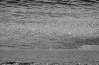 Plage de sable sombre et mer calme sur la côte sous-le-vent de Bouillante